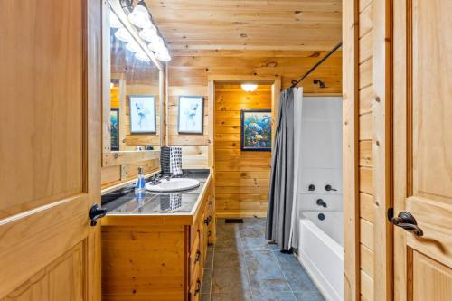 a bathroom with a sink and a tub at Starry Mountain Night- Private Pool, Pool Table in Stanton