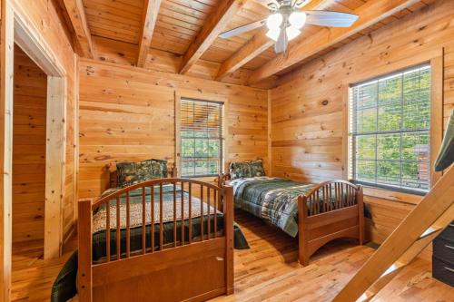 a bedroom with two bunk beds in a log cabin at Starry Mountain Night- Private Pool, Pool Table in Stanton