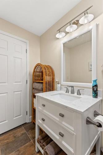 a bathroom with a white sink and a mirror at Hidden Treasure- Private Pool, Pond, 1600 Acres in Clay City