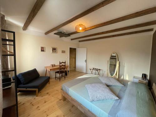 a bedroom with a large bed and a table at Cà VENDALIS Agriturismo & Cantina in Cinto Euganeo