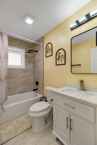 a bathroom with a toilet and a tub and a sink at Furnished Private Room in a Spacious Shared Home#3 in Norton