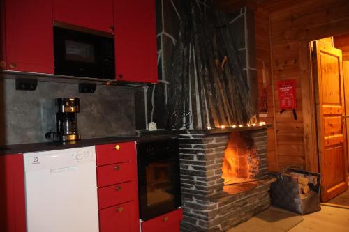 a kitchen with a brick oven in front of it at Ounasloma Holiday Cottages in Enontekiö