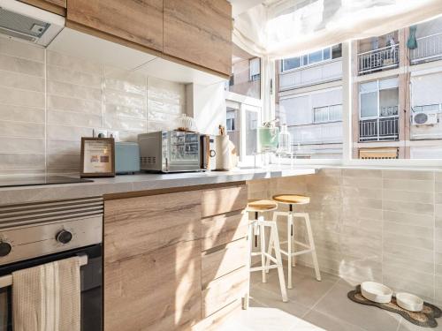 a kitchen with wooden cabinets and a counter top at Camp Nou Stadium in Barcelona