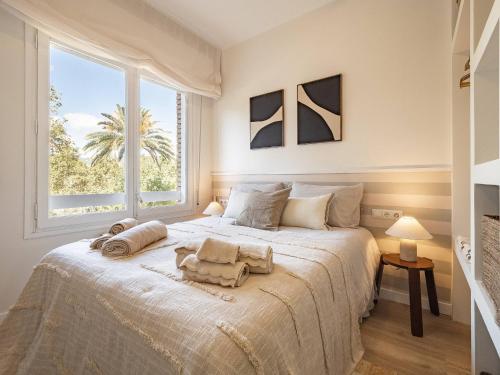a bedroom with a large white bed with two towels on it at Camp Nou Stadium in Barcelona