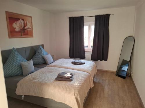 a bedroom with two beds and a couch and a window at Ferienwohnung Rose in Altenkunstadt