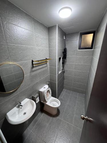 a bathroom with a toilet and a sink at Shinchan homestay in Skudai