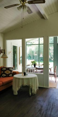 a living room with a table and a couch at Victorian Summer House On Beautiful Natural Plot in Rønde