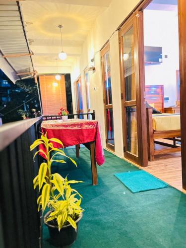 a room with a table with a red table cloth at Crest Cold Homestay in Ella