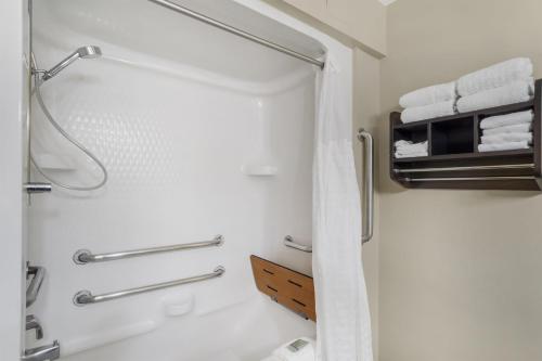 a bathroom with a shower with white towels at Best Western Kenner in Kenner