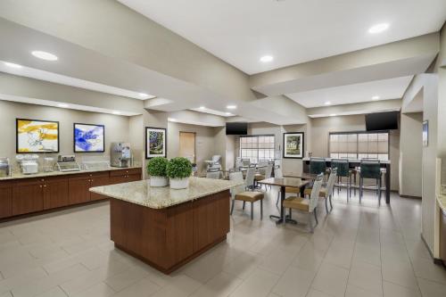 a lobby of a hospital with tables and chairs at Best Western Kenner in Kenner