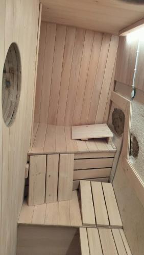 a small sauna with a bench and a fan at Gozdna koča Studeno in Kočevje