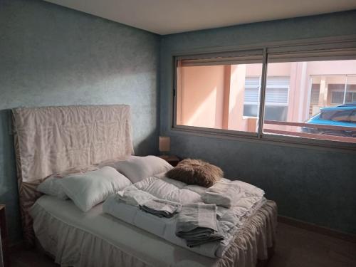 a bed in a room with a window at Waterfront apartment in Aghroud in Ti nʼ Mansour