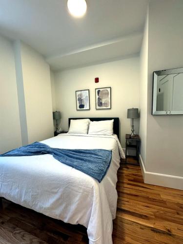 a bedroom with a large bed and a flat screen tv at Downtown Providence FREE parking in Providence
