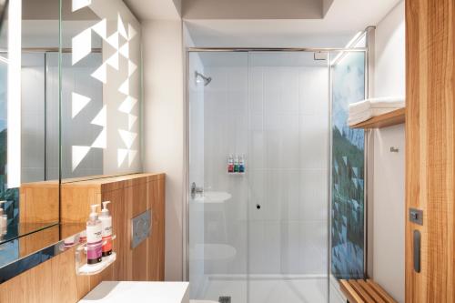 a bathroom with a shower and a sink at Alt Hotel Calgary University District in Calgary