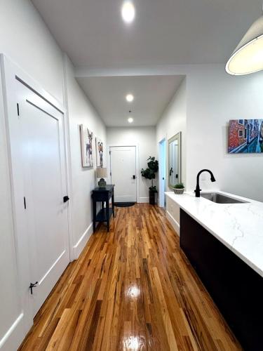 a kitchen with a sink and a wooden floor at Downtown Providence FREE parking in Providence