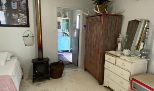 a bedroom with a bed and a dresser and a mirror at Marble Nights Damoi Parys in Vosburg