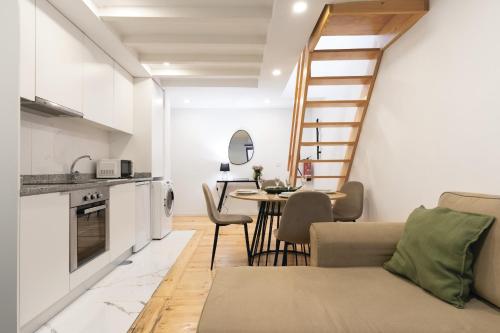 a kitchen and living room with a staircase and a table at Douro by your side with Pool in Vila Nova de Gaia