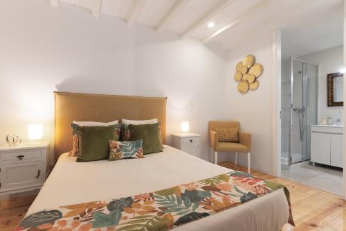 a bedroom with a large bed and a chair at Douro by your side with Pool in Vila Nova de Gaia
