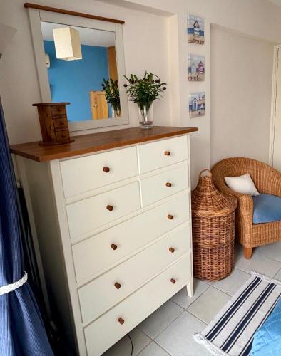 a dresser with a mirror on top of it at Kapparis Beach Escape, near beach, BBQ, free parking in Paralimni