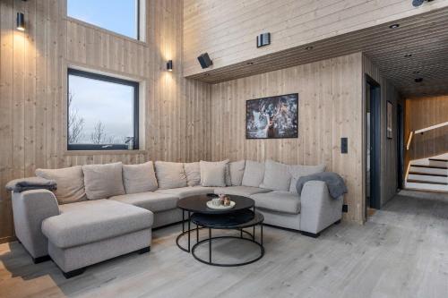 a living room with a couch and a table at GO-34B Large family cabin in Trysil next to the Gondole in Trysil