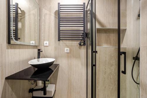 a bathroom with a sink and a mirror and a shower at OLIVA 50 - 4 Bedrooms and Office - 3 Bathrooms - Near Lisbon Expo & Airport in Lisbon
