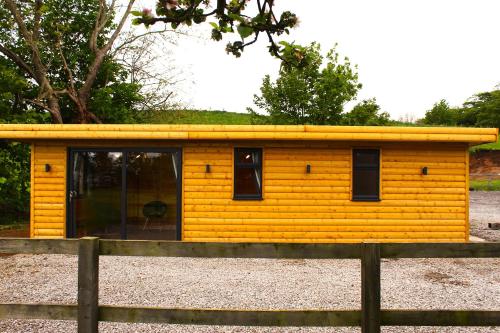 a small yellow house with a yellow roof at Paull Holme Farm Bed and Breakfast in Paull