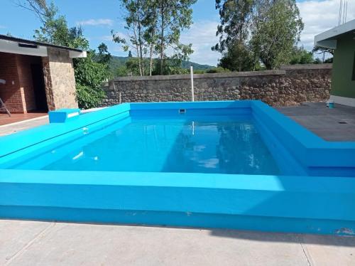 a blue swimming pool in a yard at Lozano Casa de Campo in Lozano