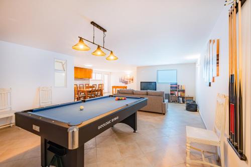 a living room with a pool table in it at Capetown Marina Luxury Villa - Private Pool in Albufeira
