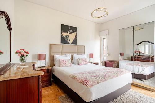 a bedroom with a large bed and a mirror at OLIVA 50 - 4 Bedrooms and Office - 3 Bathrooms - Near Lisbon Expo & Airport in Lisbon