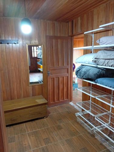 a room with a bunk bed and a mirror at Sítio em São Bonifácio in Alto Rio Bravo