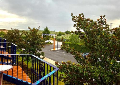 a view of a parking lot with trees and bushes at Hotel Fuente Las Piedras in Cabra