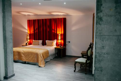 a bedroom with a bed and a red curtain at Hotel Art Santander in Santander