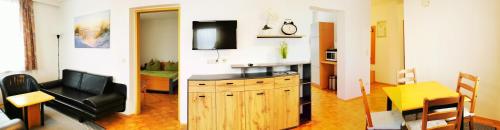 two pictures of a living room and a living room with a television at Gästehaus Lutschounig in Faak am See