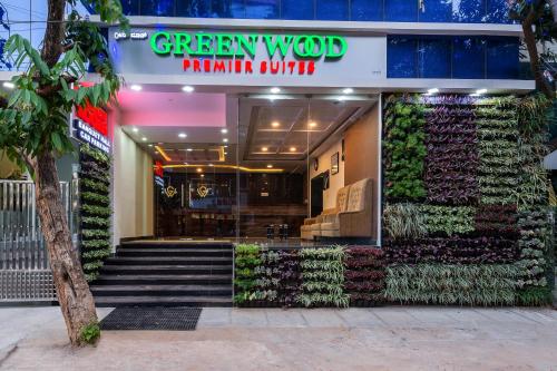a restaurant with a plant wall in front of it at Treebo Trend Greenwood Premier Suites Old Airport Road in Bangalore