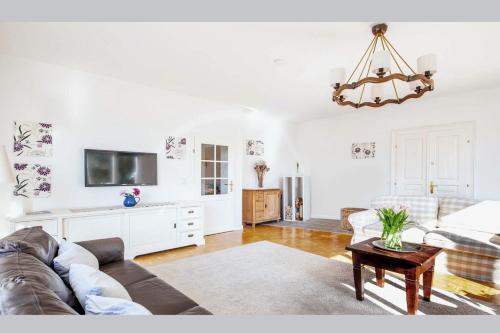a living room with a couch and a tv at White Villa in Baden