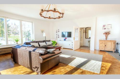 a living room with a couch and a television at White Villa in Baden