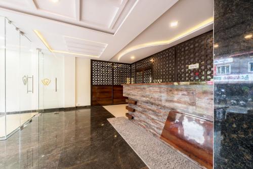 a lobby with a wall of wine bottles at Treebo Greenwood Premier Suites, Old Airport Road in Bengaluru