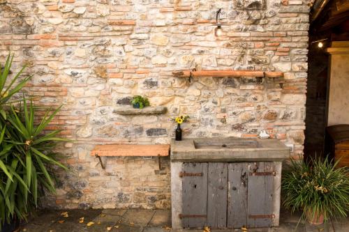 a stone wall with a stone sink in front of it at Agriturismo La Romagnana in Pistoia