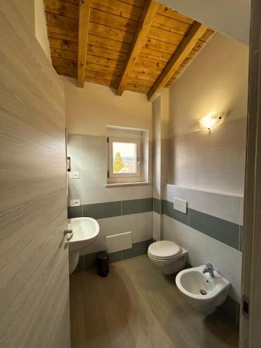 a bathroom with a toilet and a sink at Antico Borgo San Zeno in Bardolino