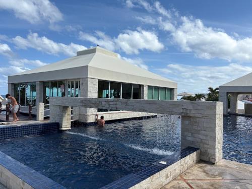 a swimming pool in front of a building at Solymar Zona Hotelera Cancún in Cancún