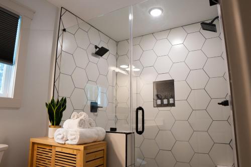 a shower with a glass door in a bathroom at Dual-Head Shower for Two-Romantic Retreat in Aerial