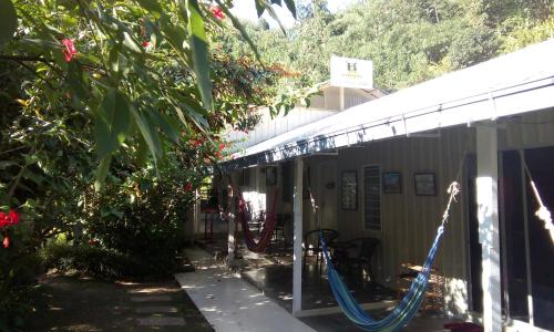 a porch with a hammock outside of a house at Moonriver Lodge in Cameron Highlands