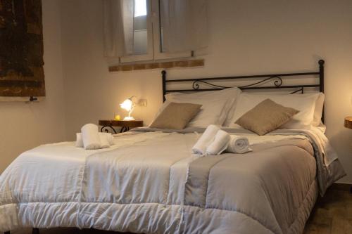 a bedroom with a large white bed with towels on it at Palazzo Marini in Spoleto