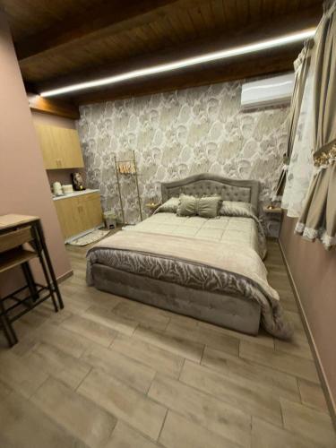 a bedroom with a bed and a stone wall at Casa Vacanze Jennifer in Catania
