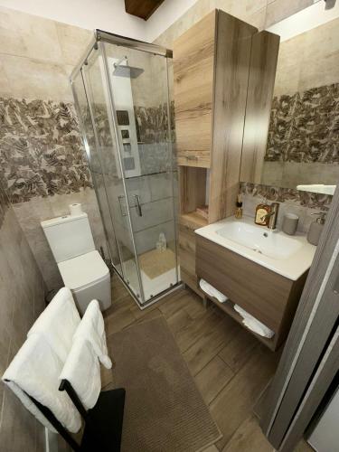 a bathroom with a shower and a toilet and a sink at Casa Vacanze Jennifer in Catania