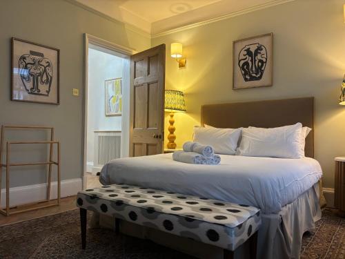 a bedroom with a large white bed and a window at Windsor Castle 4-Bed & Garden in Windsor
