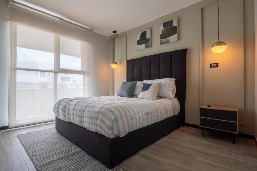 a bedroom with a large bed with a large window at Exclusive Apartment in Home Resort in La Cañada
