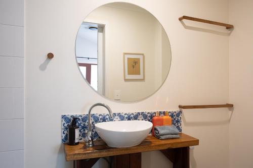 a bathroom with a sink and a mirror at Alcorn Garden Studio - Dog friendly 2 mins walk to beach in Suffolk Park