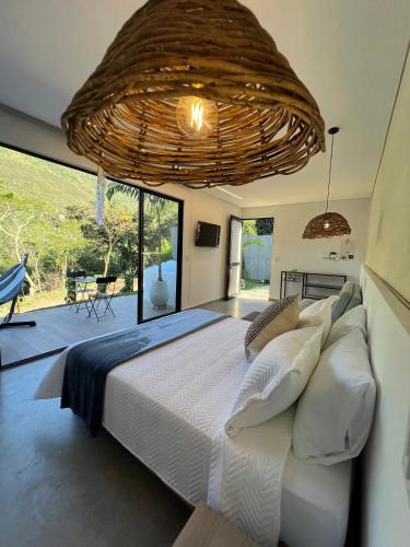 a bedroom with a large bed and a large chandelier at Glamping Del Río by Trip Monkey in San Gil