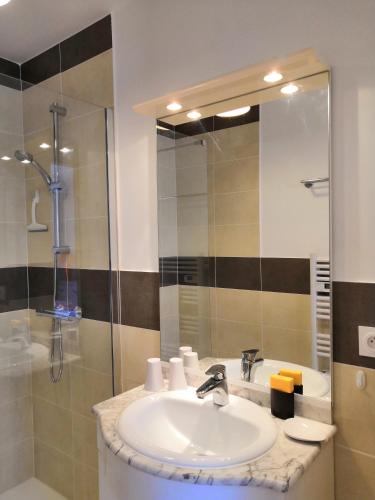 a bathroom with a sink and a shower at Villa les volets bleus in Le Grau-dʼAgde